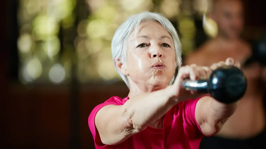 Toning Bingo Wings: Effective Exercises and Tips for Achieving Sleeker Arms 2 Person performing arm exercises with dumbbells Kingswinford